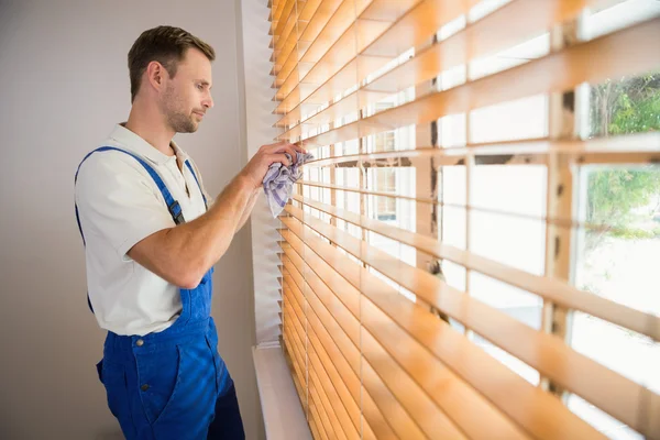 depositphotos_60926763-stock-photo-handyman-cleaning-blinds-with-a